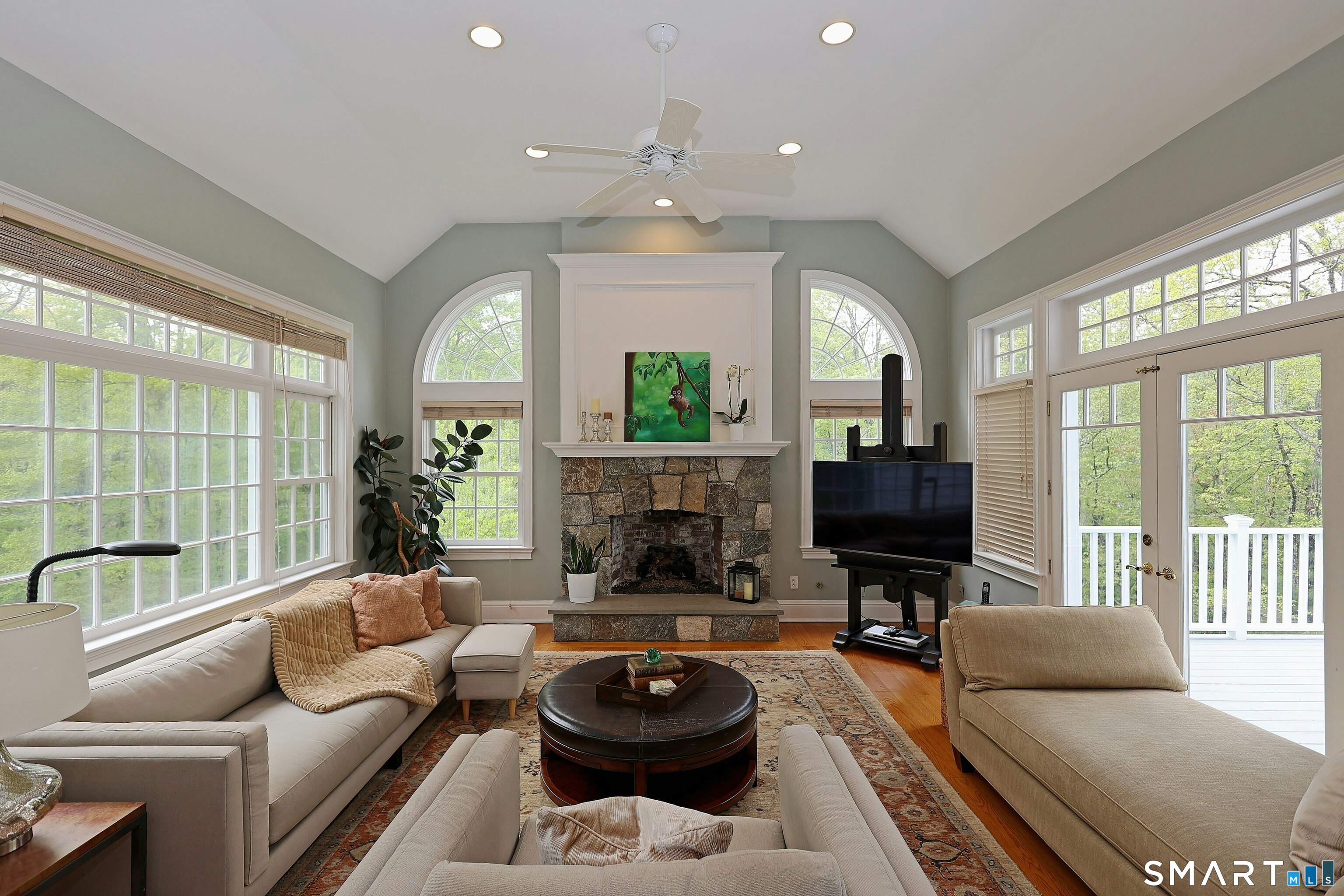 30 Whipstick Road Ridgefield, CT 06877 - Photo 18 of 40 a living room with furniture a flat screen tv and a large window
