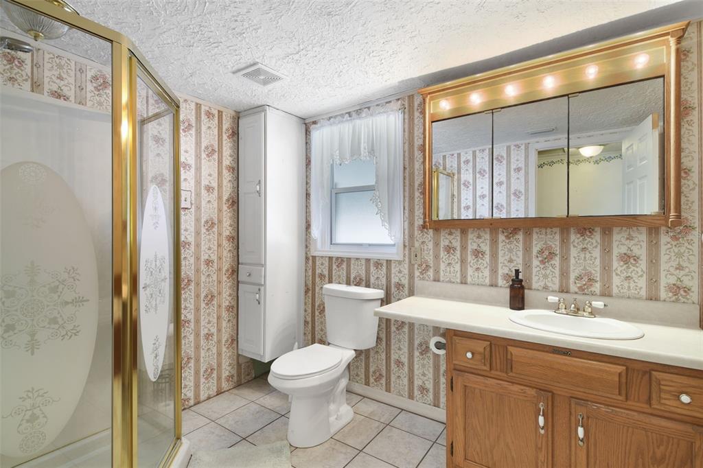 916 Fernald Street Edgewater, FL 32132 - Photo 12 of 27 a bathroom with a double vanity sink toilet and shower