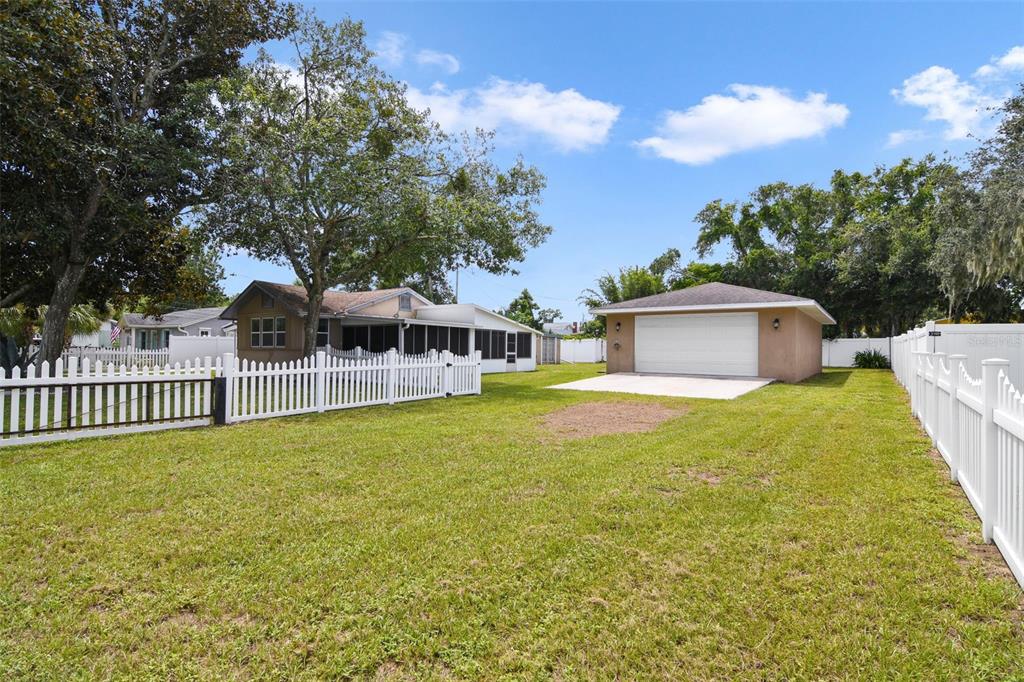916 Fernald Street Edgewater, FL 32132 - Photo 21 of 27 a front view of a house with a garden