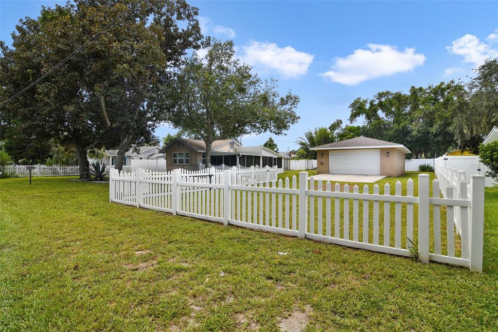 916 Fernald Street Edgewater, FL 32132 - Photo 23 of 27 a view of a house with backyard and trees