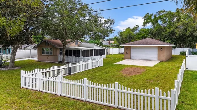a view of a house with a yard and deck