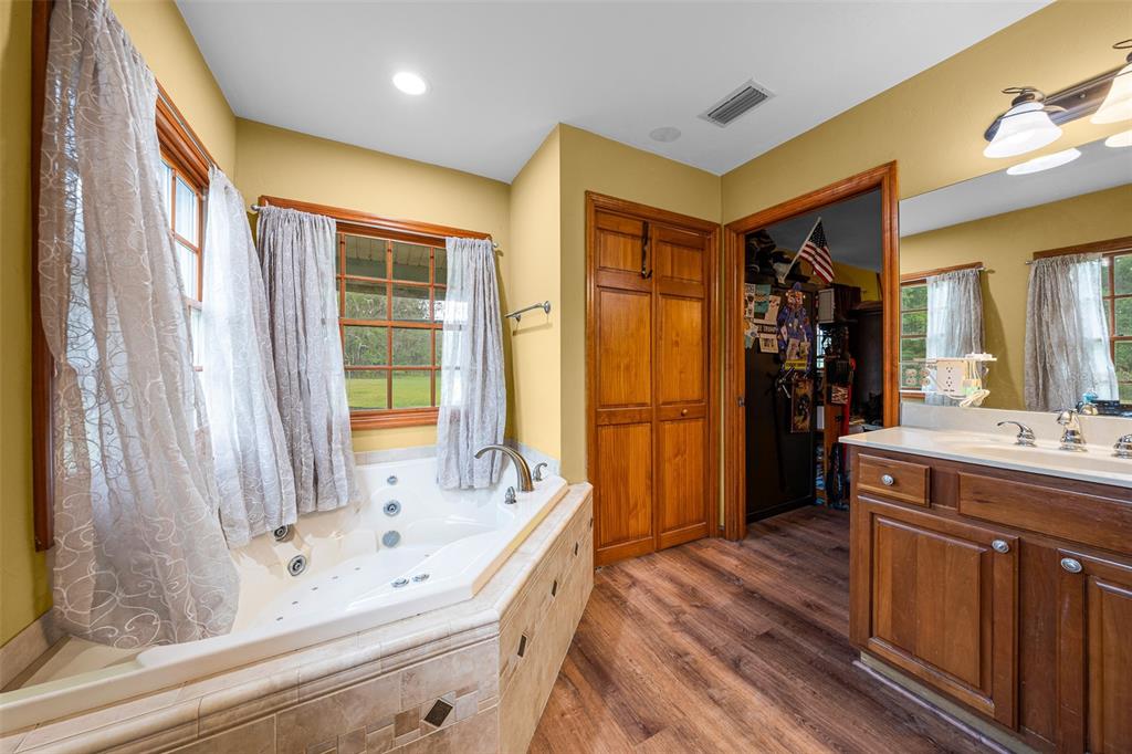 732 Carl Wilson Road Fort White, FL 32038 - Photo 23 of 80 a bathroom with a tub sink and mirror