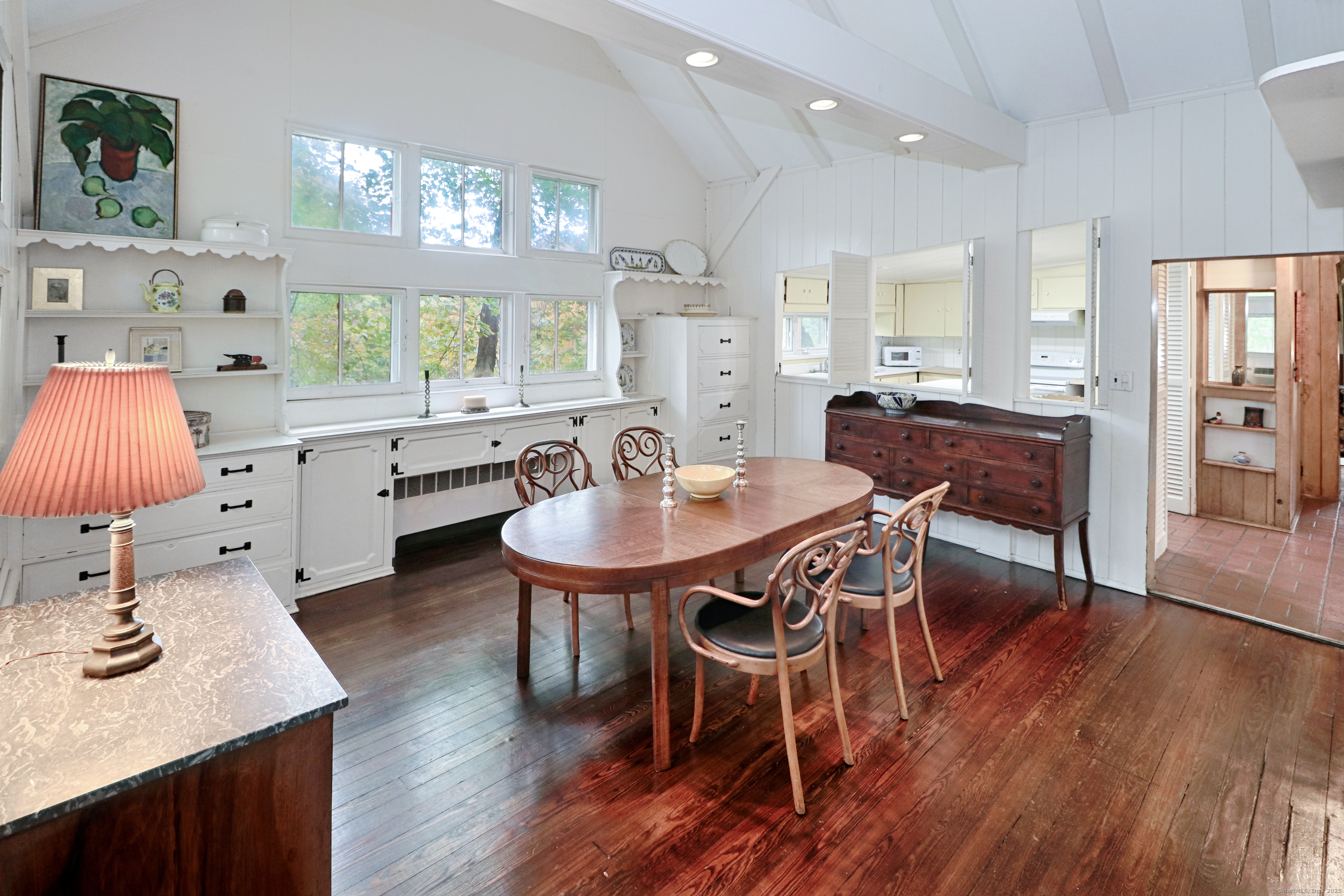 23 Bridge Street Westport, CT 06880 - Photo 16 of 39 a dining room with wooden floor a chandelier a wooden table and chairs