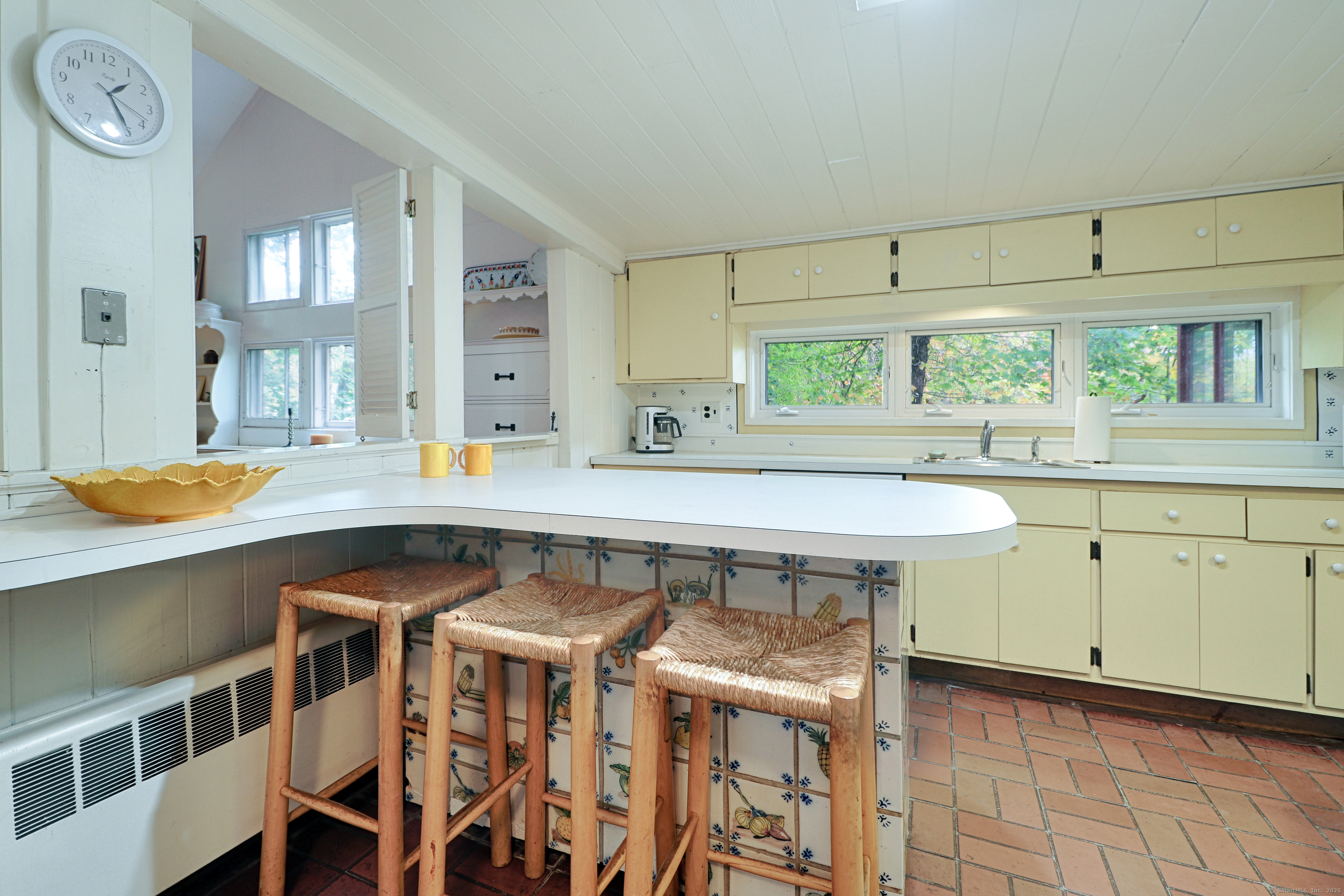 23 Bridge Street Westport, CT 06880 - Photo 18 of 39 a kitchen with a table chairs sink and cabinets