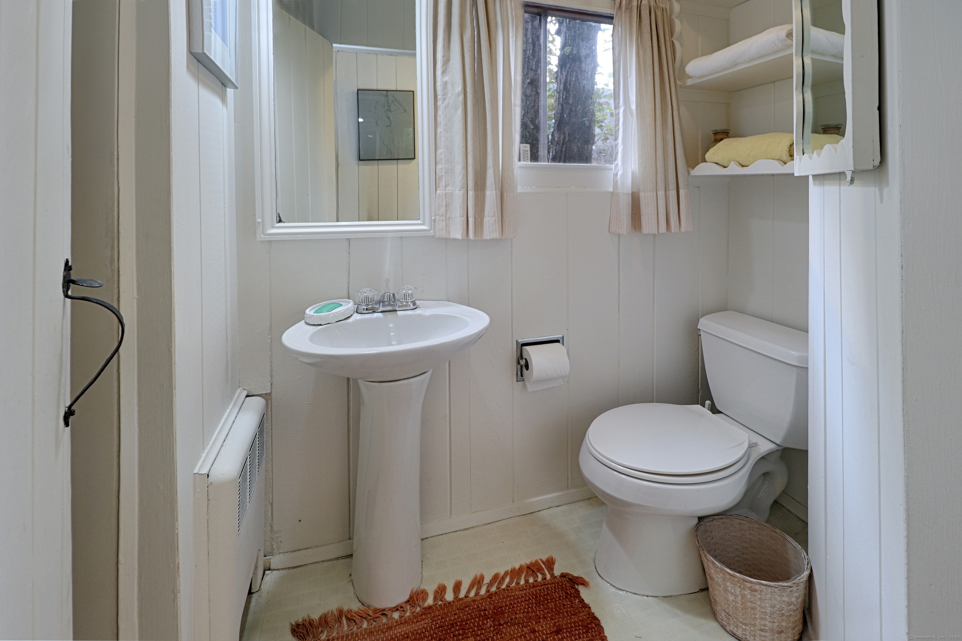 23 Bridge Street Westport, CT 06880 - Photo 21 of 39 a bathroom with a sink toilet and a mirror