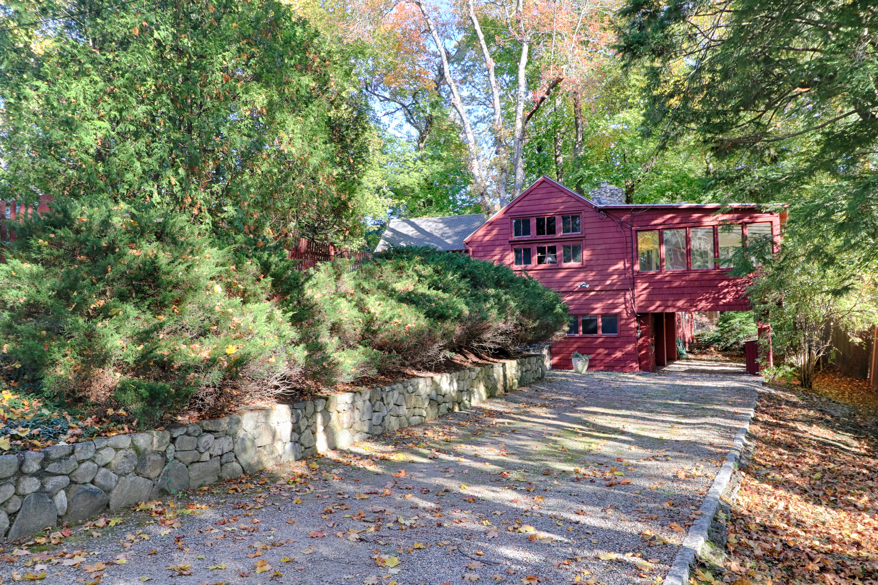 23 Bridge Street Westport, CT 06880 - Photo 5 of 39 a front view of a house with a yard and large trees