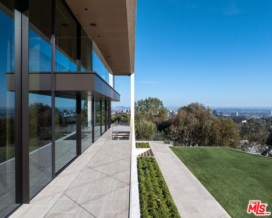 684 Firth Avenue Los Angeles, CA 90049 - Photo 11 of 27 a view of a house with a yard