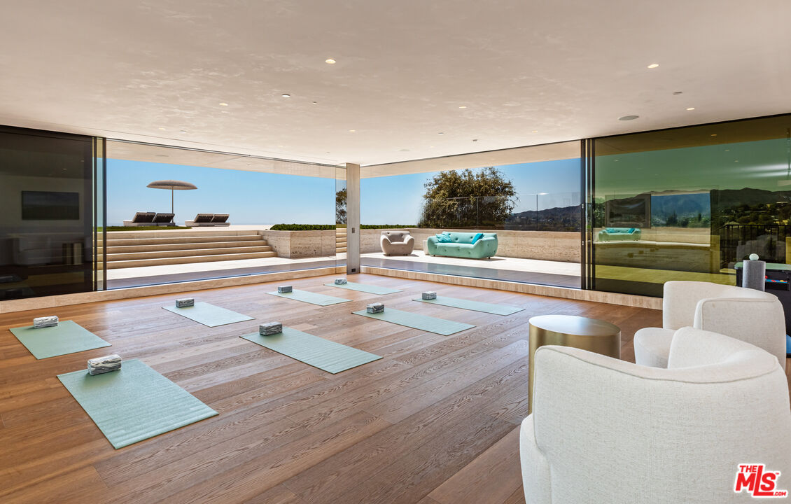 684 Firth Avenue Los Angeles, CA 90049 - Photo 13 of 27 a living room with couch and a floor to ceiling window
