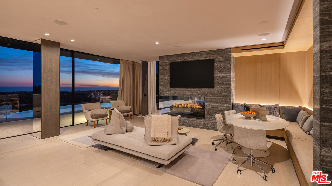 684 Firth Avenue Los Angeles, CA 90049 - Photo 17 of 27 a living room with furniture and a flat screen tv