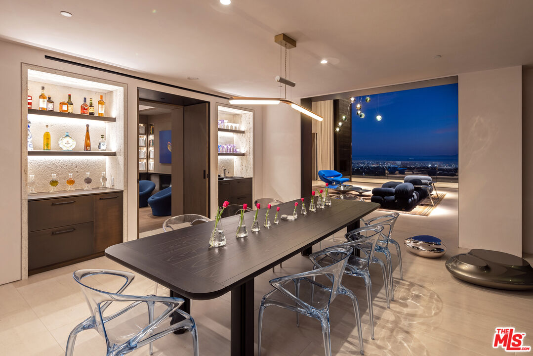 684 Firth Avenue Los Angeles, CA 90049 - Photo 20 of 27 a kitchen with a table chairs and a refrigerator