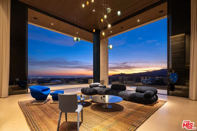 a living room with patio furniture and a floor to ceiling window