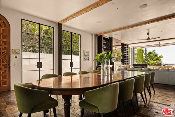 a view of a dining room with furniture and a potted plant