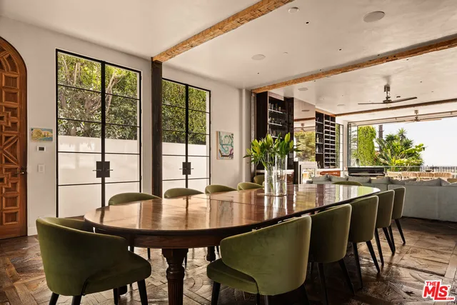 a view of a dining room with furniture and a potted plant