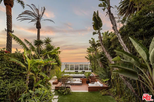 a view of a backyard with seating area and green space