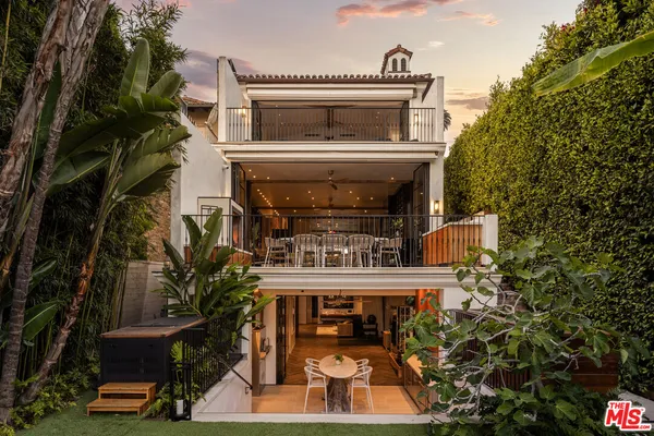 a living room with furniture and large windows