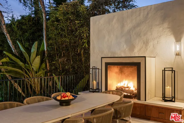 a large bedroom with a bed couch and a large window