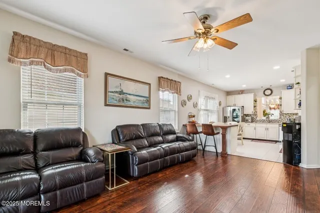 a living room with furniture and kitchen view