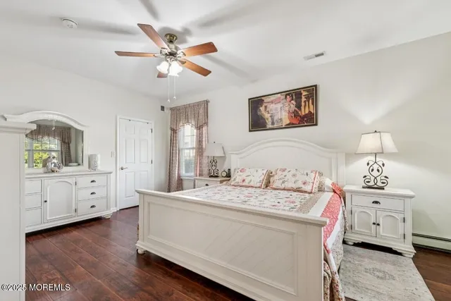 a room with a bed and a dresser