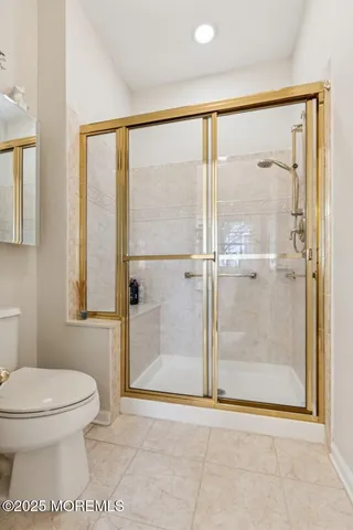 a bathroom with a toilet and a shower