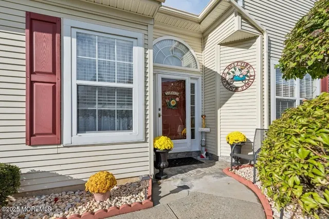 a view of a two chairs in the back yard of the house