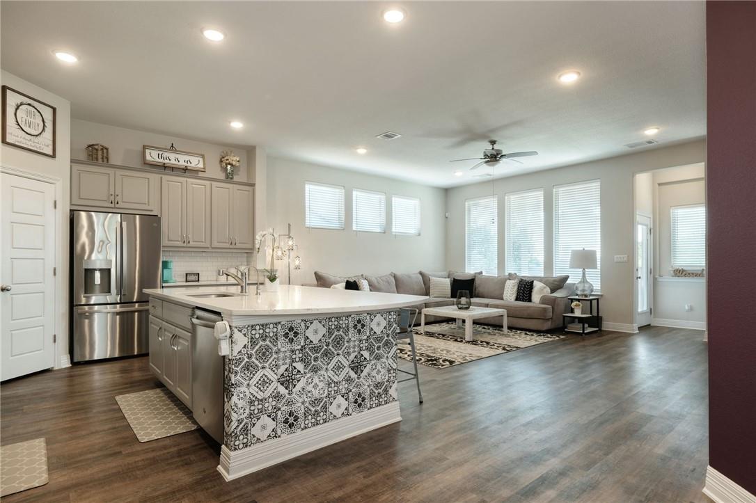 229 Bonnet Boulevard Georgetown, TX 78628 - Photo 1 of 20 Kitchen featuring gray cabinets, stainless steel appliances, backsplash, a center island with sink, and recessed lighting