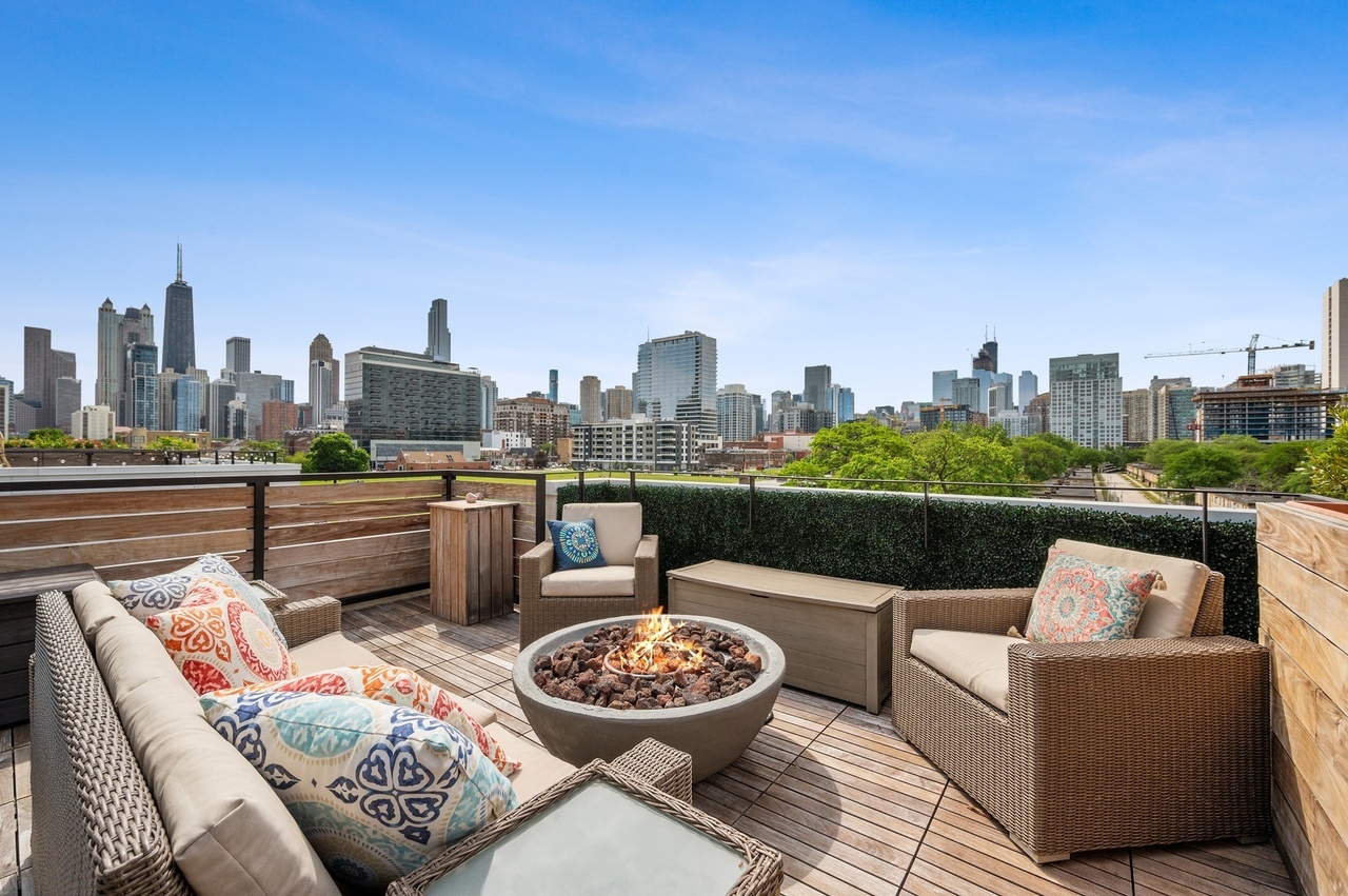 448 West Oak Street Chicago, IL 60610 - Photo 17 of 28 a view of a roof deck with couches and potted plants