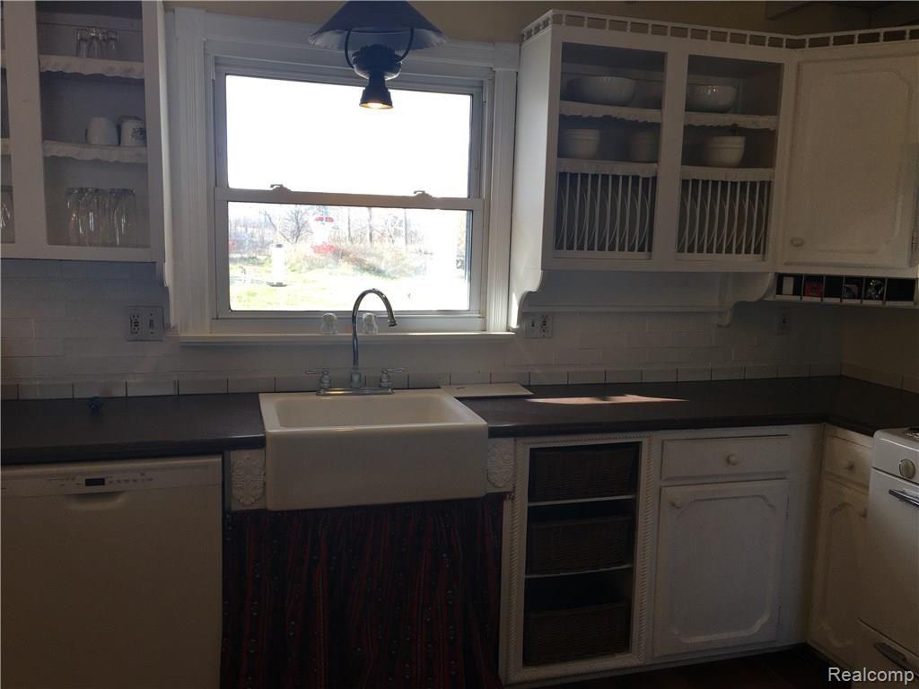8451 Wiggins Road Howell, MI 48855 - Photo 13 of 23 Kitchen with unique light fixtures and open shelving.