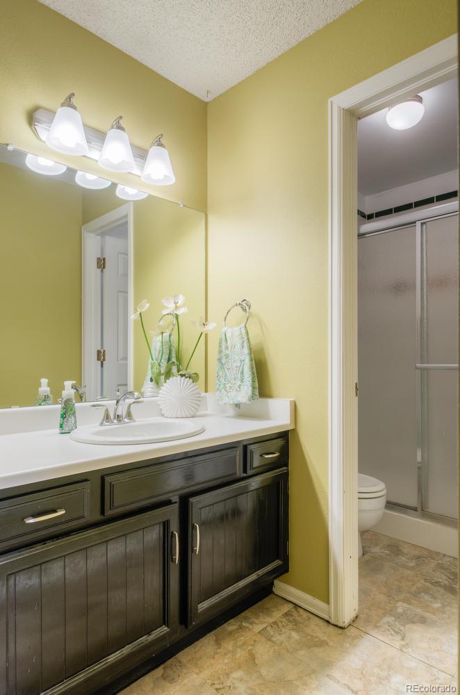 705 Northridge Road Highlands Ranch, CO 80126 - Photo 6 of 7 a bathroom with a double vanity sink and a mirror