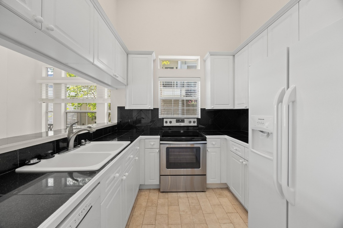 2918 Ranch Road 620 North, Unit X201 Austin, TX 78734 - Photo 15 of 30 a kitchen with a sink stove and refrigerator