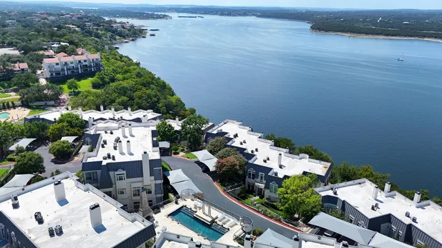an aerial view of multiple houses with yard