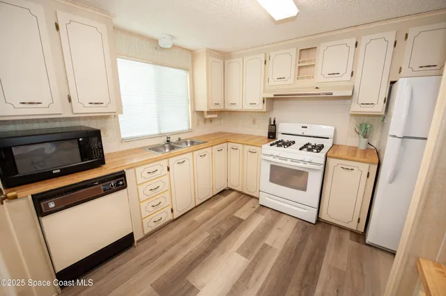 a bed sitting in a bedroom next to a bathroom