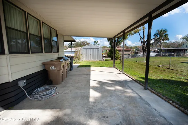 a view of a house with backyard and a tree