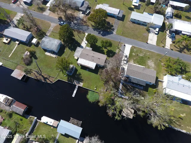 an aerial view of a house with a yard basket ball court and outdoor seating