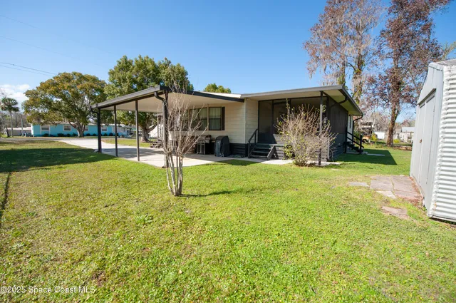 a view of a house with a wooden fence
