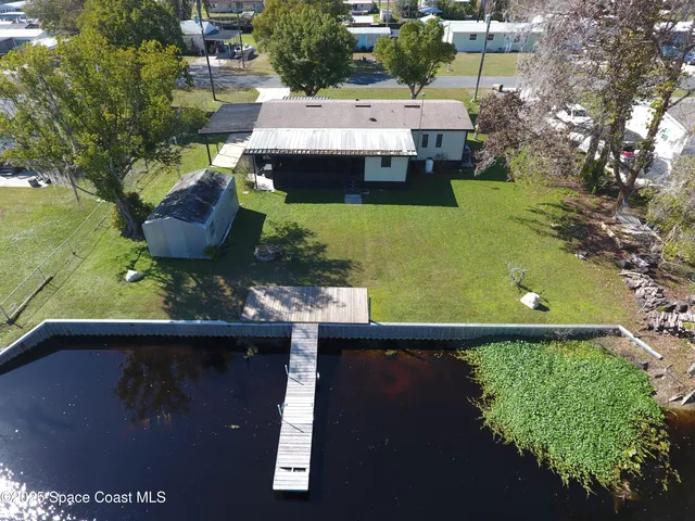 an aerial view of house with yard swimming pool and outdoor seating