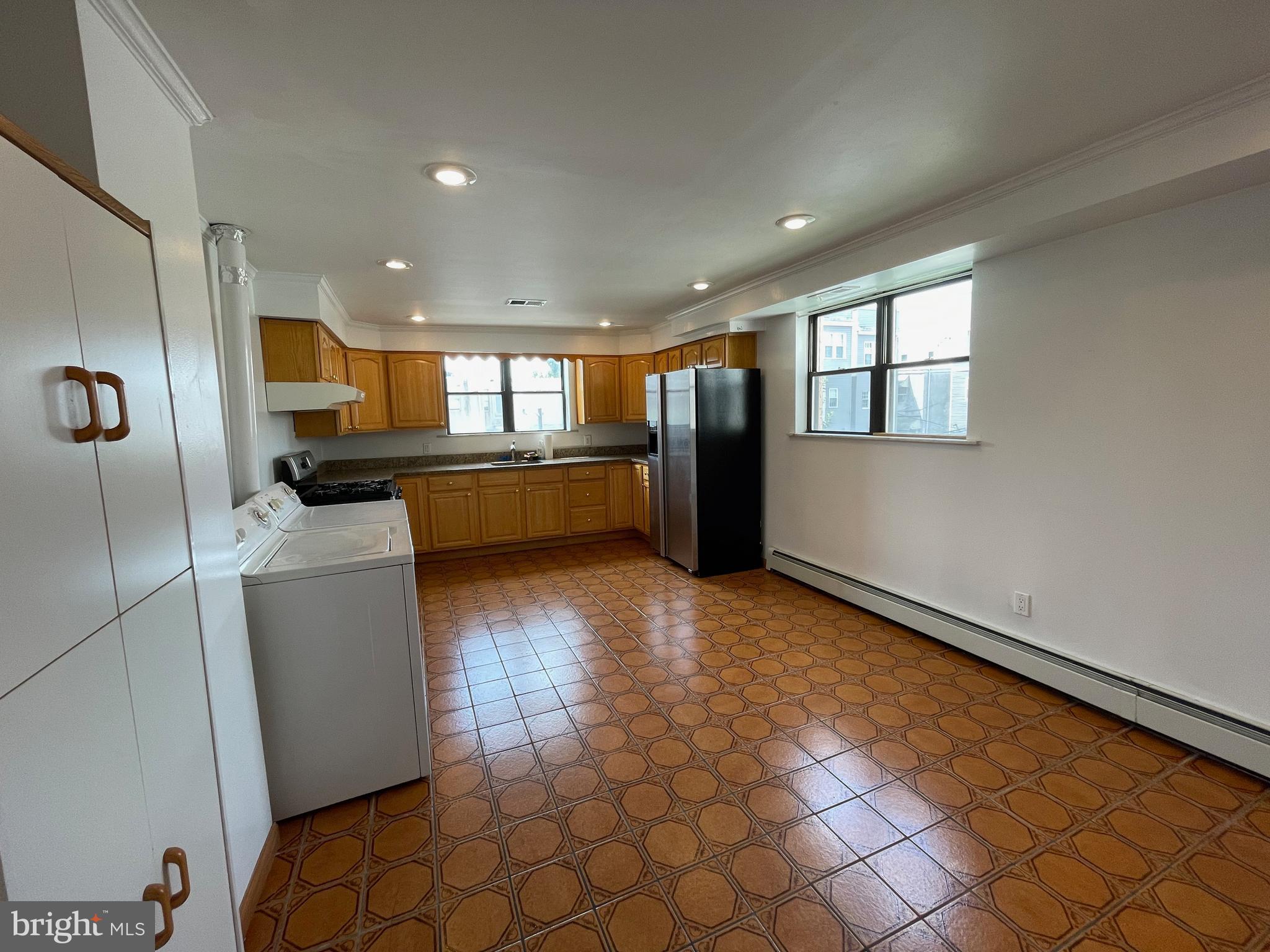 1230 Federal Street Philadelphia, PA 19147 - Photo 2 of 12 a kitchen with stainless steel appliances a refrigerator and a stove top oven