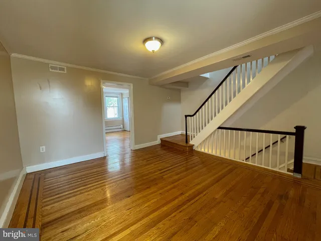 a view of entryway and hall with wooden floor