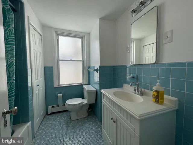 a bathroom with a sink toilet and mirror