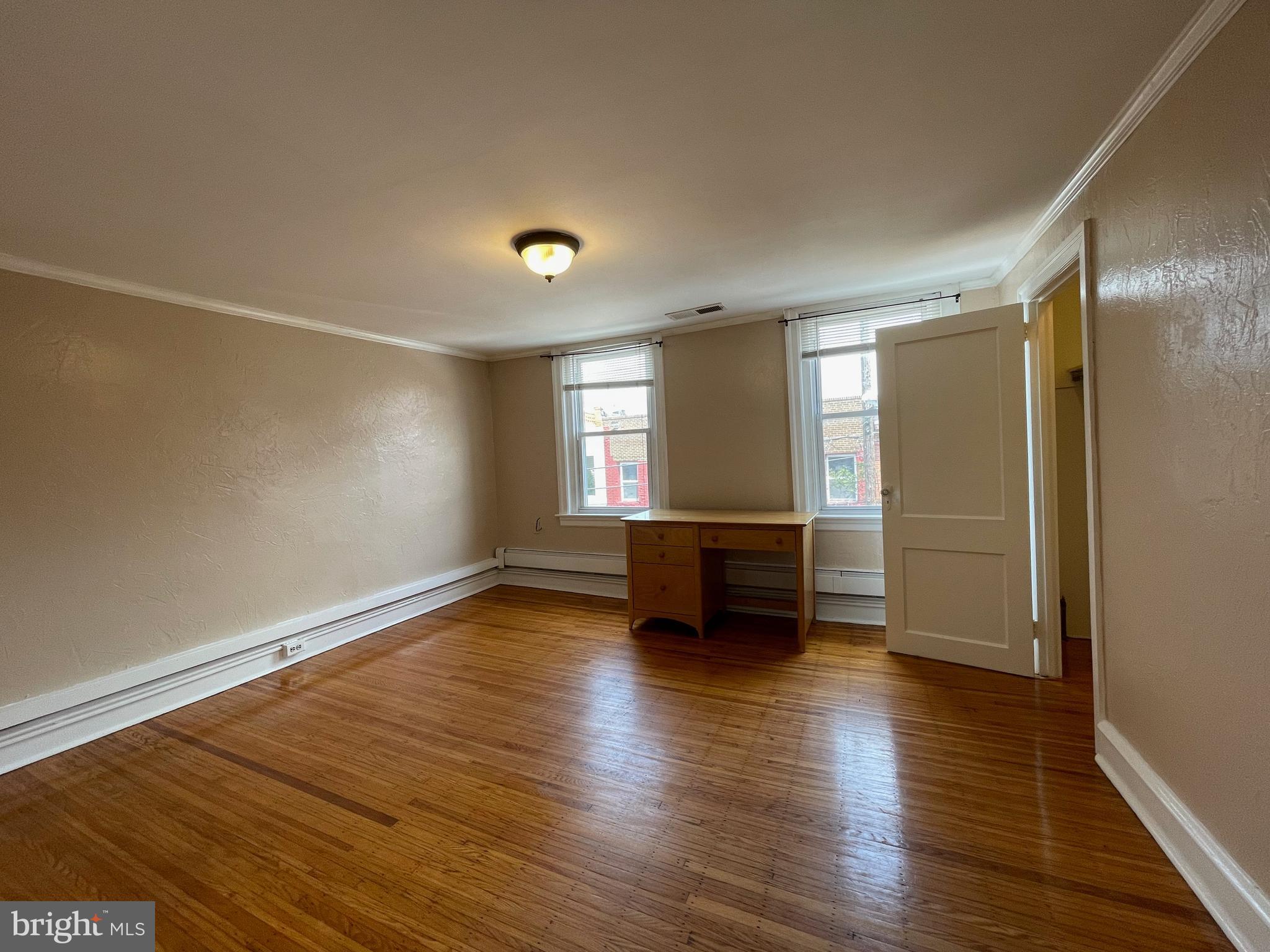 1230 Federal Street Philadelphia, PA 19147 - Photo 8 of 12 an empty room with wooden floor and windows