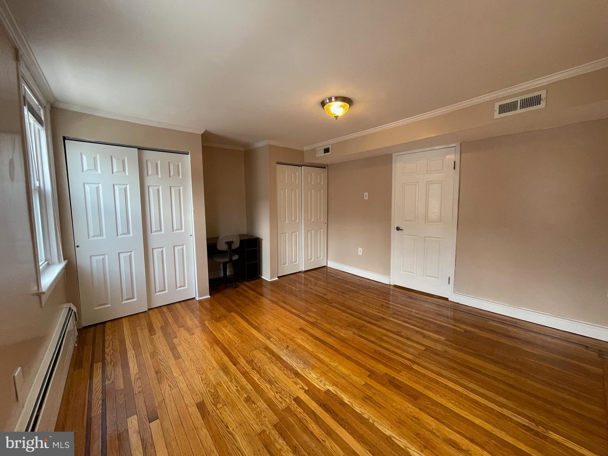 1230 Federal Street Philadelphia, PA 19147 - Photo 9 of 12 a view of an empty room with wooden floor and a window