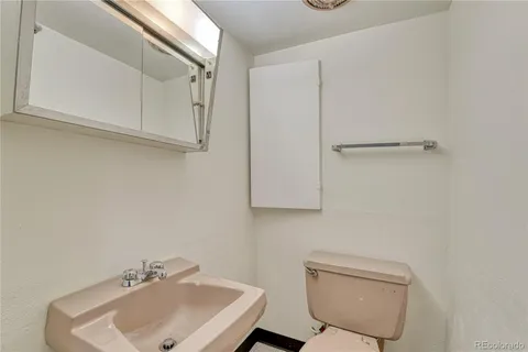 a bathroom with a sink a toilet and vanity