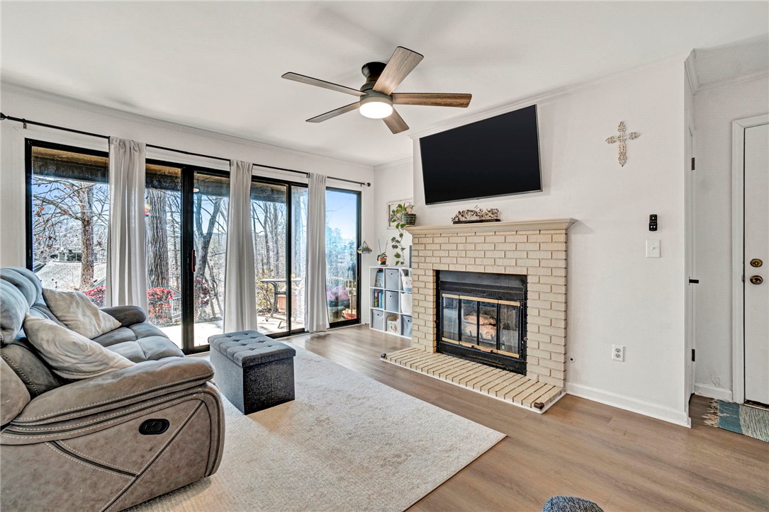 104 Captains Way Anderson, SC 29625 - Photo 4 of 47 This inviting living space features a cozy fireplace and expansive glass doors opening to outdoor views.
