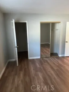 an empty room with wooden floor and closet