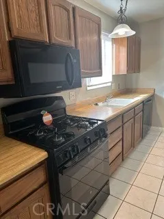 a kitchen with a stove a sink and a cabinets