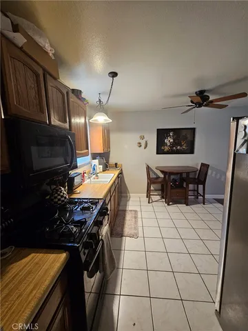 a kitchen with a stove a sink and a refrigerator