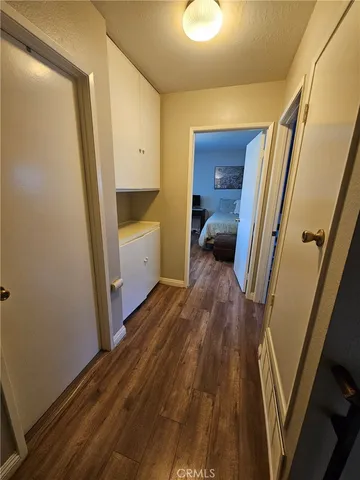 a view of a hallway view with wooden floor and staircase
