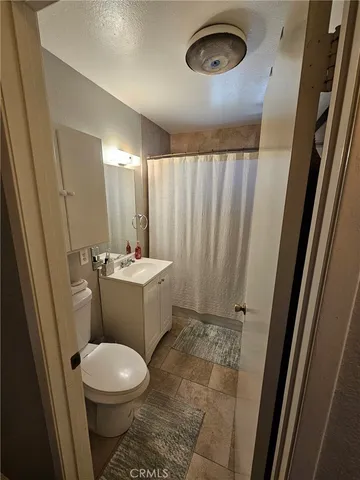 a bathroom with a sink a toilet a mirror and vanity