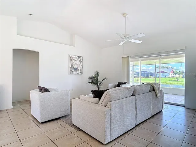 a kitchen with stainless steel appliances a dining table chairs and a refrigerator