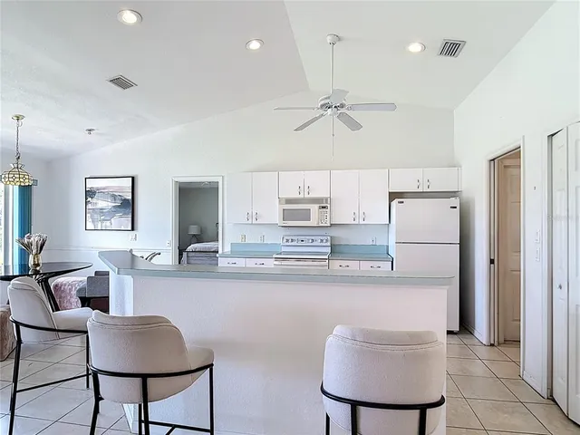 a kitchen with stainless steel appliances granite countertop white cabinets a stove a sink and dishwasher