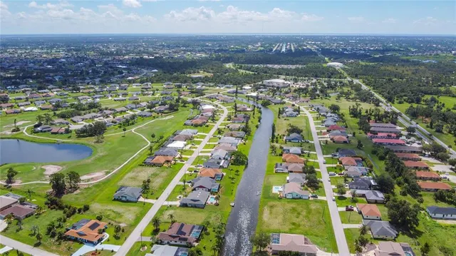 an aerial view of residential building and lake
